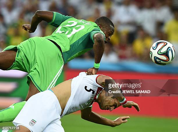 Nigeria's forward Shola Ameobi fights for the ball with Iran's defender Amir Hossein Sadeqi during a Group F football match between Iran and Nigeria...