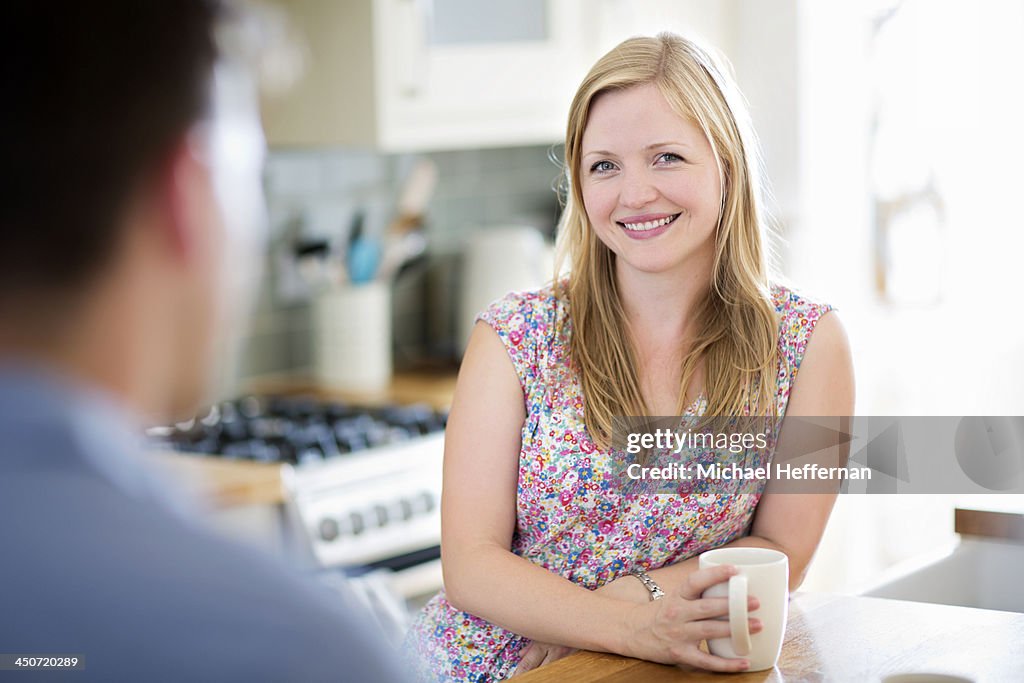 Woman in kitchen smiling at camera