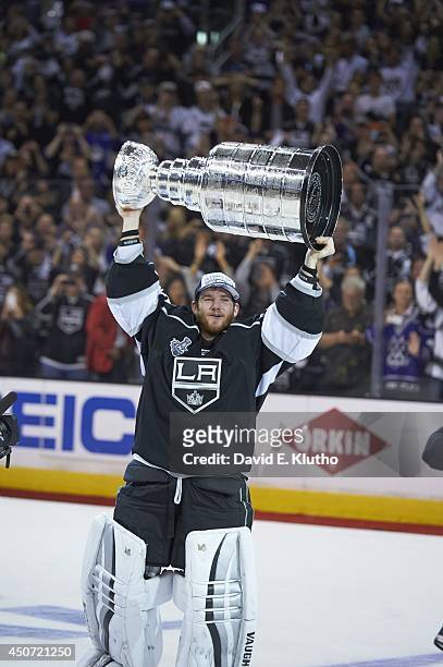 Los Angeles Kings goalie Jonathan Quick victorious, holding up Stanley Cup after winning game and series vs New York Rangers at Staples Center. Game...