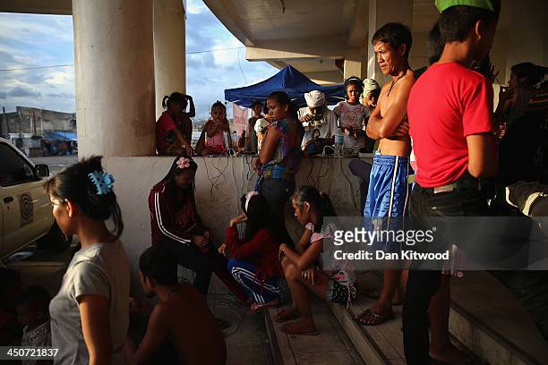 Displaced people gather to charge their phones outside the Tacloban astrodome evactuatuion centre on November 20, 2013 in Leyte, Philippines. Typhoon...