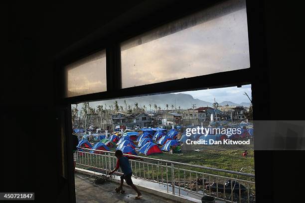 Boy plays on a skateboard at the Tacloban astrodome evactuatuion centre on November 20, 2013 in Leyte, Philippines. Typhoon Haiyan which ripped...