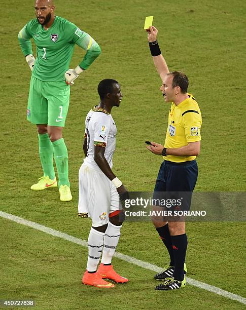 Ghana's midfielder Mohammed Rabiu receives a yellow card from Swedish referee Jonas Eriksson during a Group G football match between Ghana and US at...