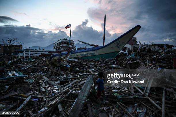 Boy climbs across debris near the Tacloban astrodome evactuatuion centre on November 20, 2013 in Leyte, Philippines. Typhoon Haiyan which ripped...