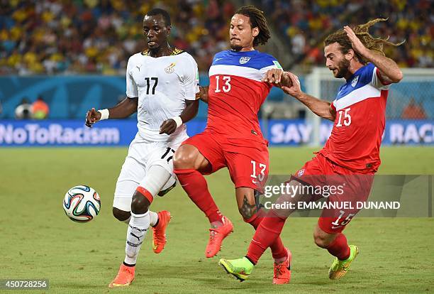 Ghana's midfielder Mohammed Rabiu vies with US midfielder Jermaine Jones and US midfielder Kyle Beckerman during a Group G football match between...