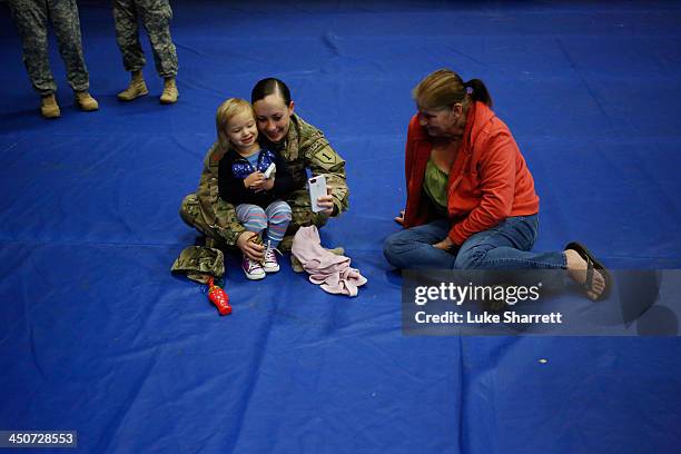 Sgt. Michelle Porter of the U.S. Army's 3rd Brigade Combat Team, 1st Infantry Division, takes a photo with her 2-year-old daughter Jade Porter...