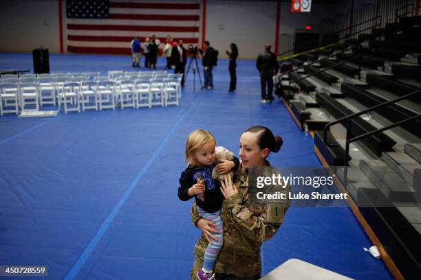 Sgt. Michelle Porter of the U.S. Army's 3rd Brigade Combat Team, 1st Infantry Division, holds her 2-year-old daughter Jade Porter following a...