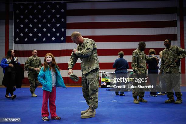 Jason Beals of the U.S. Army's 3rd Brigade Combat Team, 1st Infantry Division, stands with his 7-year-old daughter Madyson Beals following a...