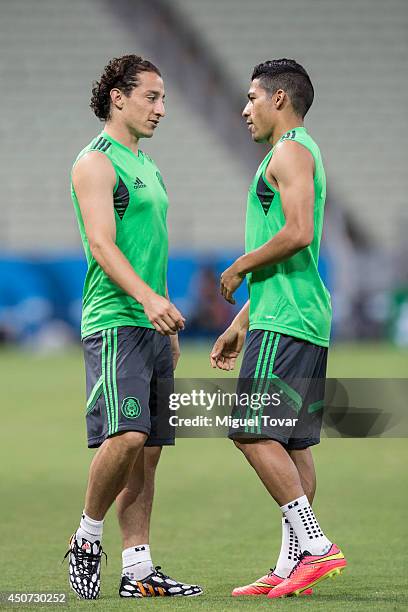 Andres Guardado and Javier Aquino of Mexico talk during a training session at Castelao Stadium on June 16, 2014 in Fortaleza, Brazil.