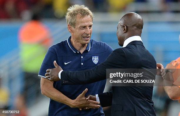 Ghana's coach Kwesi Appiah congratulates US German coach Juergen Klinsmann after a Group G football match between Ghana and US at the Dunas Arena in...