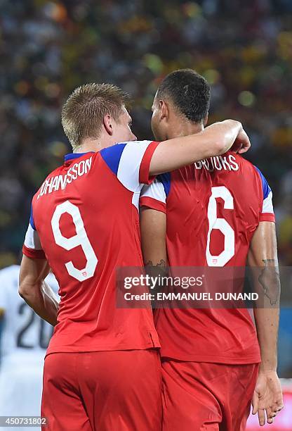 Defender John Brooks and US forward Aron Johannsson celebrate at the end of a Group G football match between Ghana and US at the Dunas Arena in Natal...