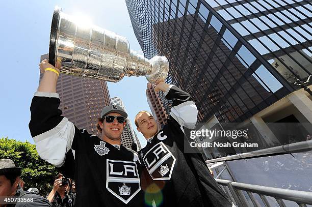 Anze Kopitar and Dustin Brown of the Los Angeles Kings celebrate with the Stanley Cup Trophy during the Los Angeles Kings victory parade and rally on...