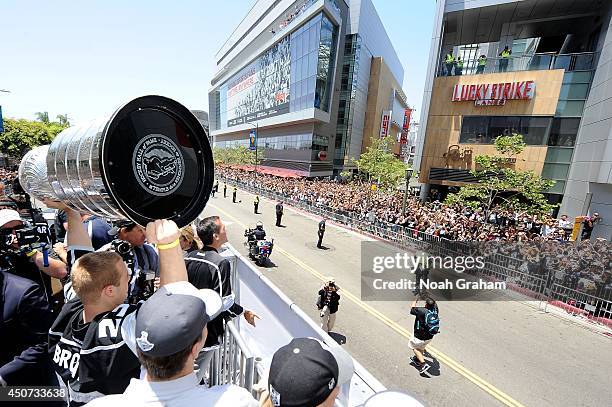 Dustin Brown of the Los Angeles Kings shows the Stanley Cup Trophy to the crowd during the Los Angeles Kings victory parade and rally on June 16,...