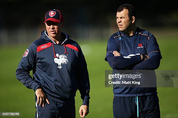 Roosters coach Trent Robinson speaks to Waratahs coach Michael Cheika during a joint training session between the Waratahs and the Sydney Roosters at...