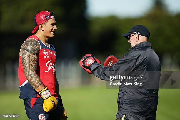 Sonny Bill Williams of the Roosters boxes with trainer Johnny Lewis during a joint training session between the Waratahs and the Sydney Roosters at...