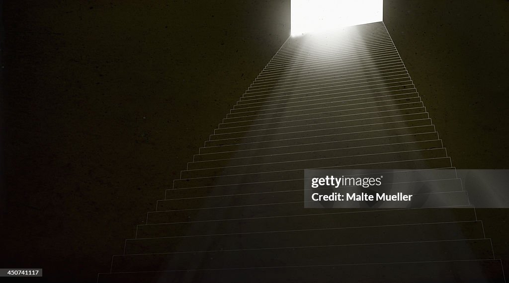 Stairs leading up to a brightly illuminated doorway