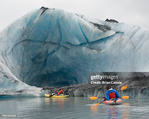 kayaking beside ice cave at valdez glacier, alaska, usa - valdez stock pictures, royalty-free photos & images