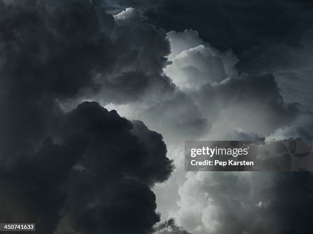 a dramatic cloudscape of black and white clouds - 不安定な空模様 ストックフォトと画像