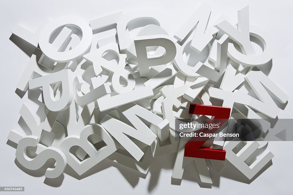 A heap of white block letters with a red letter Z