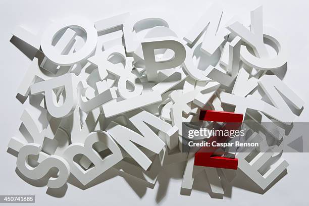 a heap of white block letters with a red letter z - letter z stock pictures, royalty-free photos & images