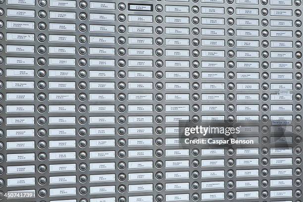 rows of doorbells on a metal panel - timbre de la puerta fotografías e imágenes de stock