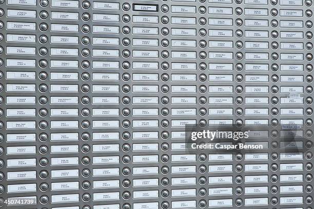 rows of doorbells on a metal panel - citofono foto e immagini stock