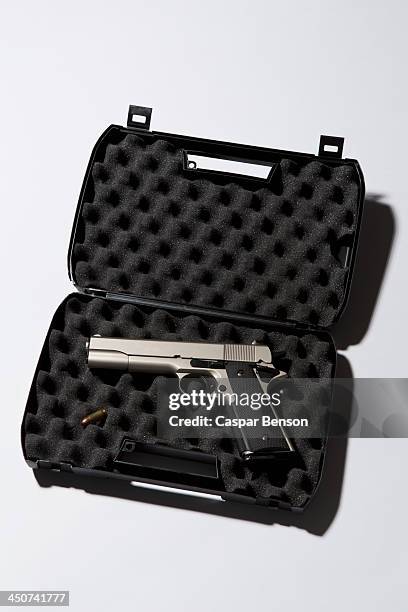 a handgun in a protected briefcase with a bullet - weapon stock pictures, royalty-free photos & images