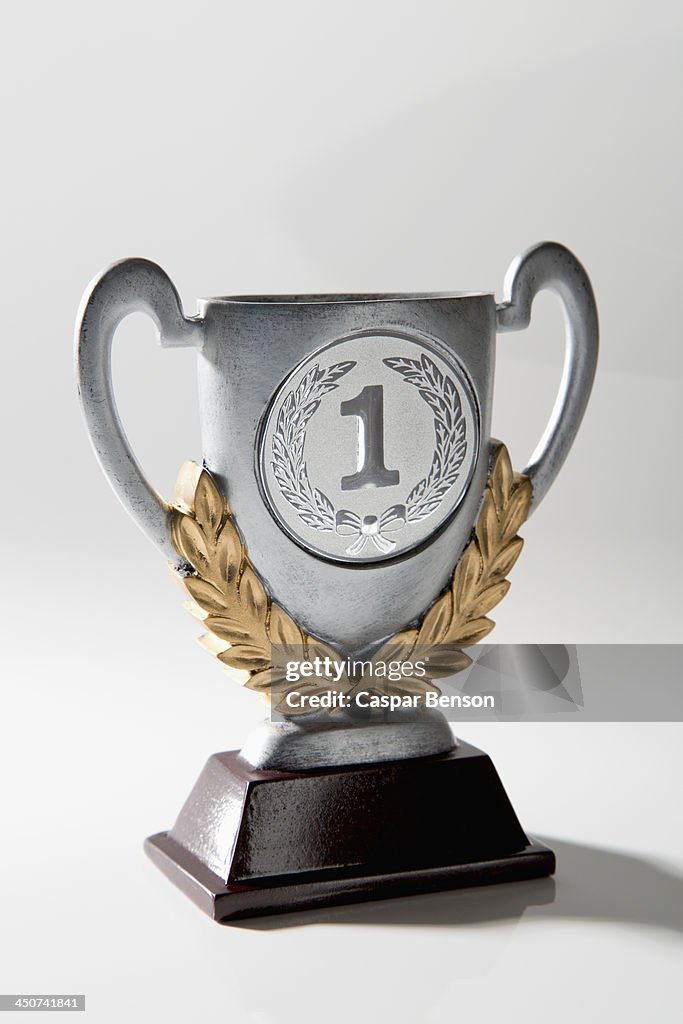 A silver first place trophy with gold laurel wreath embellishment
