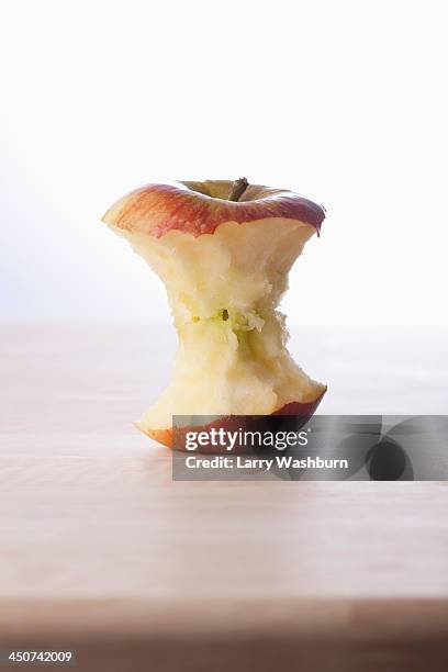 a fresh apple core on a table - corazón de manzana fotografías e imágenes de stock