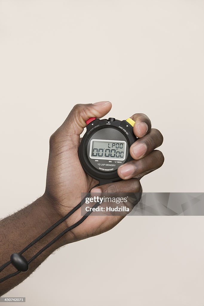 Man holding digital stopwatch