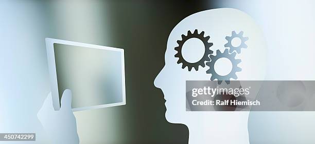 graphic of a man in profile with a cogs in his head looking at a tablet - holding tablet computer stock illustrations