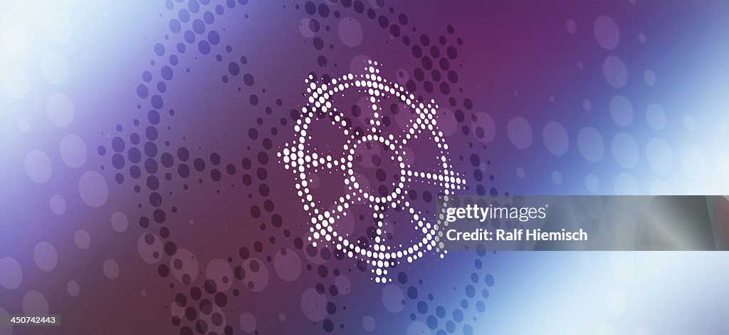 Buddhist dharmacakra symbol (wheel of life) reflected on abstract surface