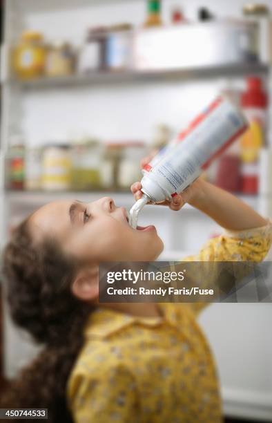 girl eating whipped cream from can - cream mouth stock-fotos und bilder