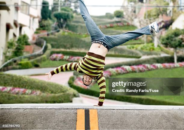man doing cartwheel on street - lombard street san francisco fotografías e imágenes de stock