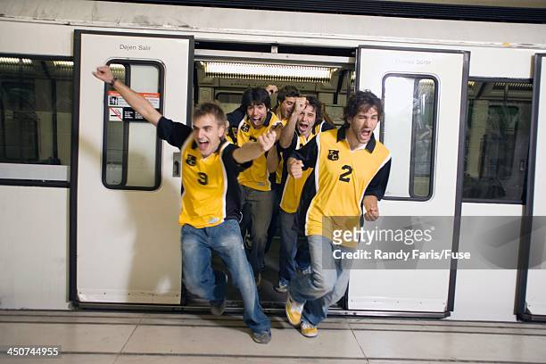 excited sports fans leaving subway - train transport stockfoto's en -beelden