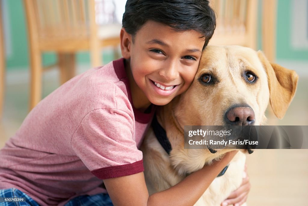 Boy Cuddling with Dog