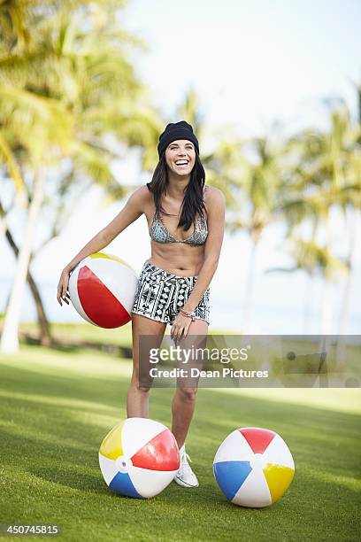 young woman playing with beach balls in park - tuques stock pictures, royalty-free photos & images