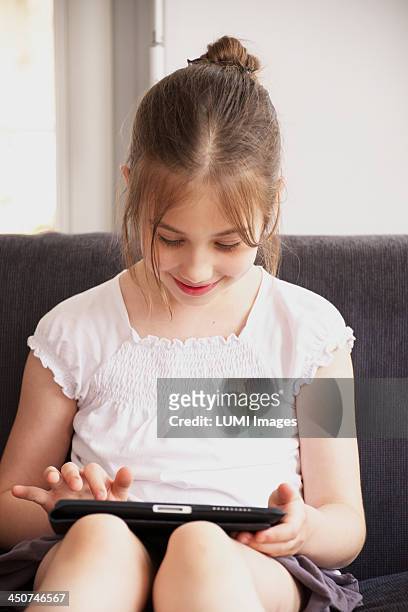 girl (10-12) with tablet pc, munich, germany - girl 11 12 laughing close up foto e immagini stock