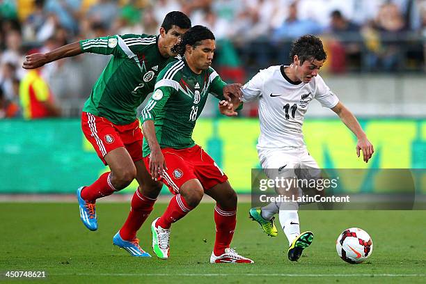 Carlos Peña and Francisco Javier Rodriguez of Mexico compete against Marco Rojas of New Zealand during leg 2 of the FIFA World Cup Qualifier match...