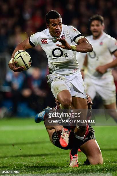 England's left wing Anthony Watson is tackled by Canterbury Crusaders player Joe Moody during their rugby union match at AMI Stadium in Christchurch...