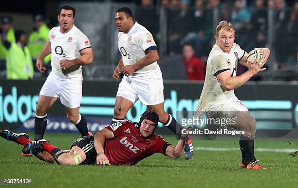 Matt Kvesic of England is held by Matt Todd during the match between the Crusaders and England at the AMI Stadium on June 17, 2014 in Christchurch,...