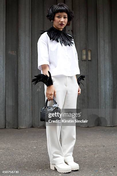 Fashion Director for Numero Thailand Fame Boonyasit wears a Jil Sanders top and trousers, Vagabond shoes, Topshop bag and custom made feathers on day...