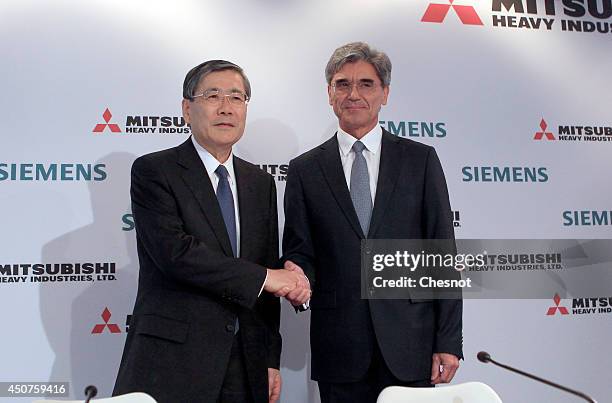 Mitsubishi Heavy Industries CEO Shunichi Miyanaga and Siemens CEO Joe Kaeser Shake hands after a press conference about Siemens-MHI proposals for...