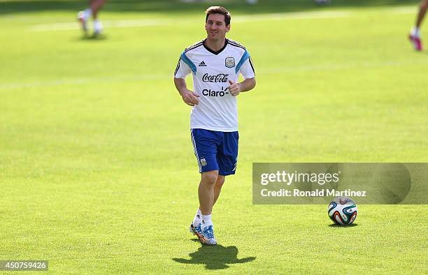 Lionel Messi of Argentina warms up during a training session at Cidade do Galo on June 17, 2014 in Vespasiano, Brazil.