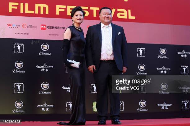 Hostess Yang Lan and her husband Wu Zheng walk the red carpet at the 17th Shanghai International Film Festival on June 14, 2014 in Shanghai, China.