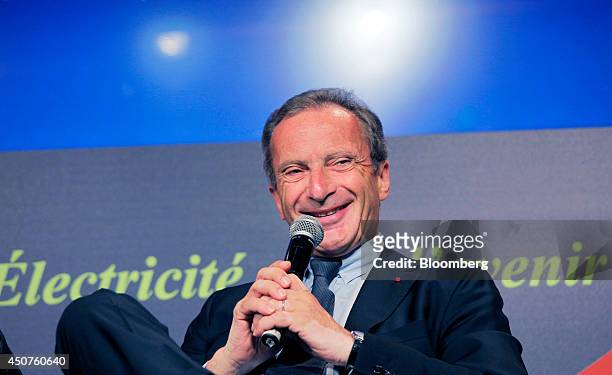 Henri Proglio, chairman of Electricite de France SA , reacts as holds a microphone while speaking at the annual symposium of the Union Francaise de...
