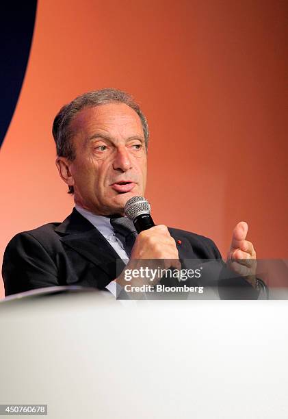 Henri Proglio, chairman of Electricite de France SA , holds a microphone as he speaks at the annual symposium of the Union Francaise de L'Electicite...