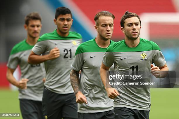 Tommy Oar of the Socceroos and team mates warm up during an Australian Socceroos training session and press conference at Estadio Beira-Rio on June...