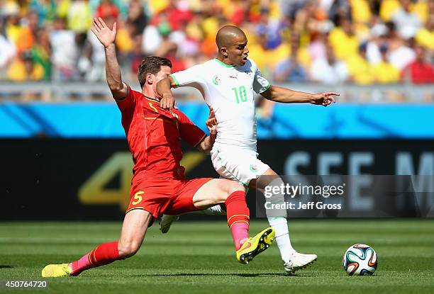 Jan Vertonghen of Belgium challenges Sofiane Feghouli of Algeria during the 2014 FIFA World Cup Brazil Group H match between Belgium and Algeria at...