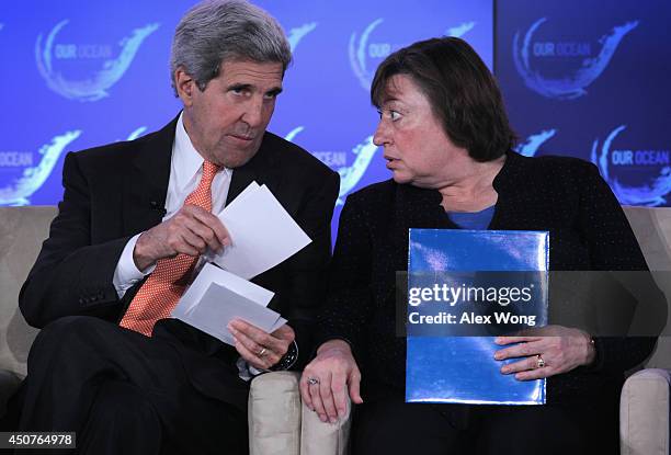 Secretary of State John Kerry talks to Under Secretary Catherine Novelli during the second and the final day of the "Our Ocean" conference June 17,...