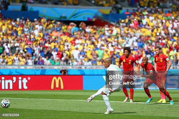 Sofiane Feghouli of Algeria scores his team's first goal on a penalty kick during the 2014 FIFA World Cup Brazil Group H match between Belgium and...